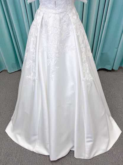 Morilee 2643 Rosemarie A-line wedding dress on mannequin with sweetheart plunging neckline, long sleeves, and frosted embroidered lace appliques