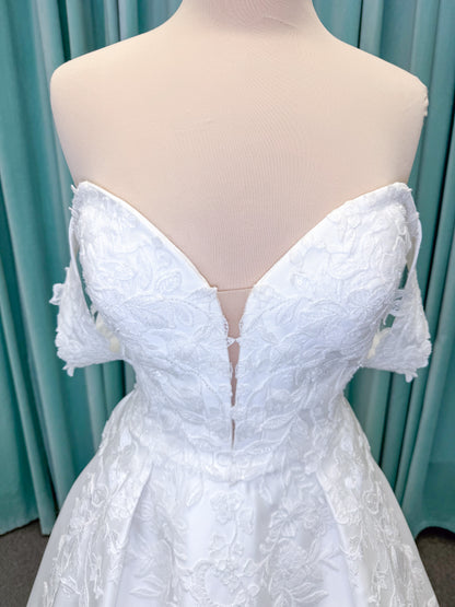 Morilee 2643 Rosemarie A-line wedding dress on mannequin with sweetheart plunging neckline, long sleeves, and frosted embroidered lace appliques