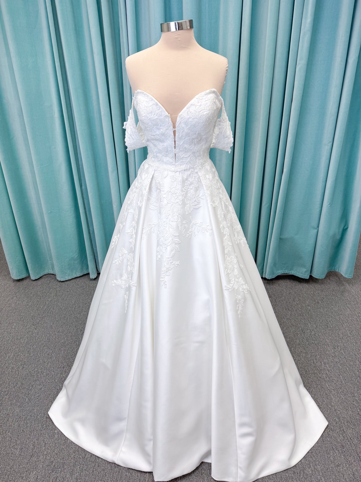 Morilee 2643 Rosemarie A-line wedding dress on mannequin with sweetheart plunging neckline, long sleeves, and frosted embroidered lace appliques