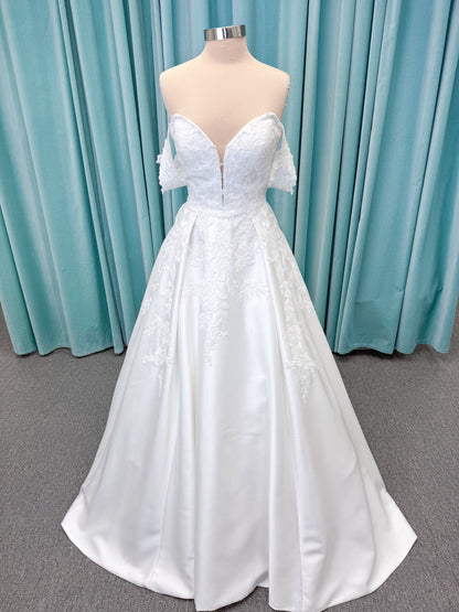 Morilee 2643 Rosemarie A-line wedding dress on mannequin with sweetheart plunging neckline, long sleeves, and frosted embroidered lace appliques