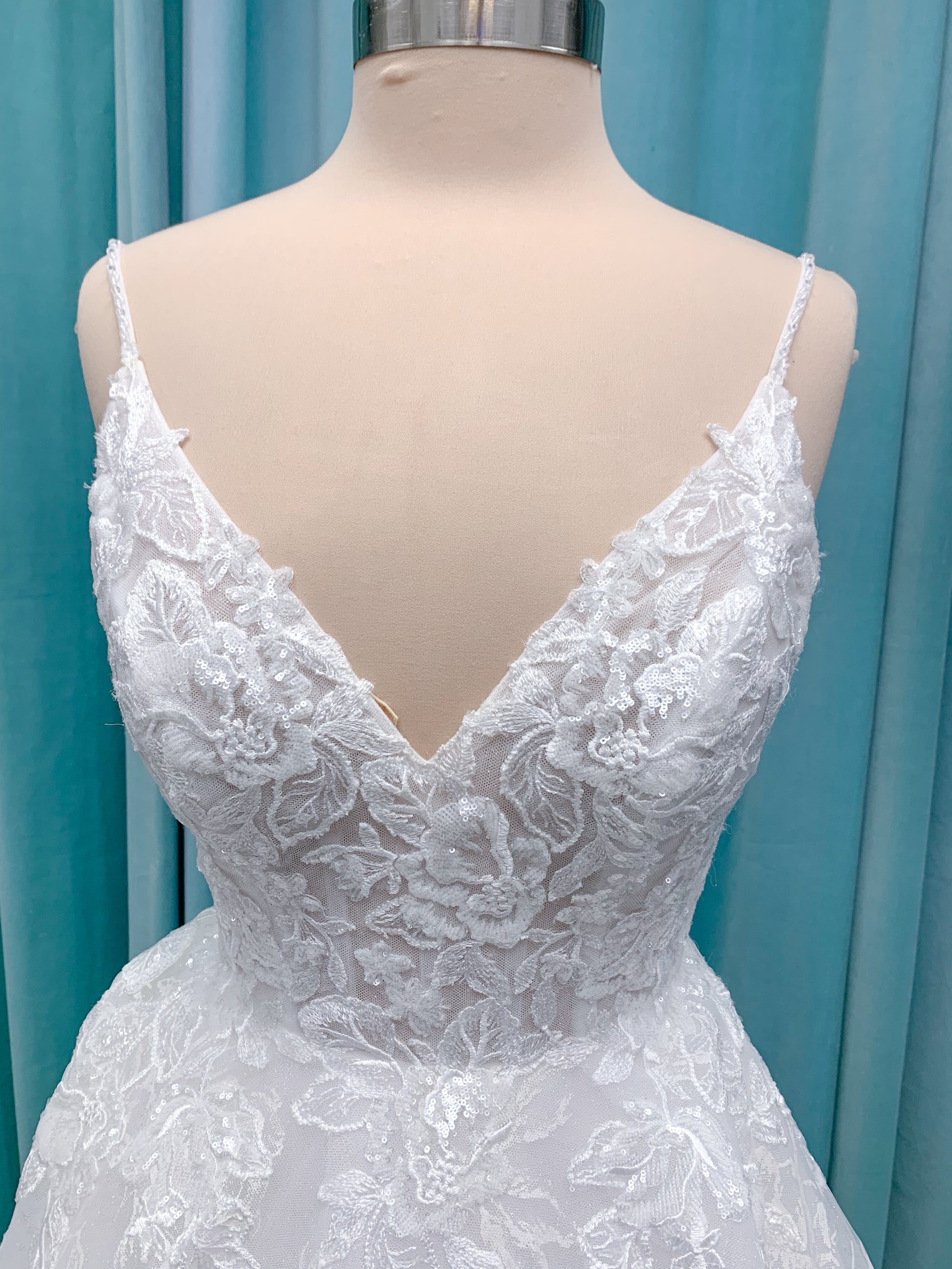 Morilee 2988 Rosie ball gown wedding dress in rose-printed organza over glitter tulle with V-neck, thin straps, structured boning, and voluminous sweeping train.