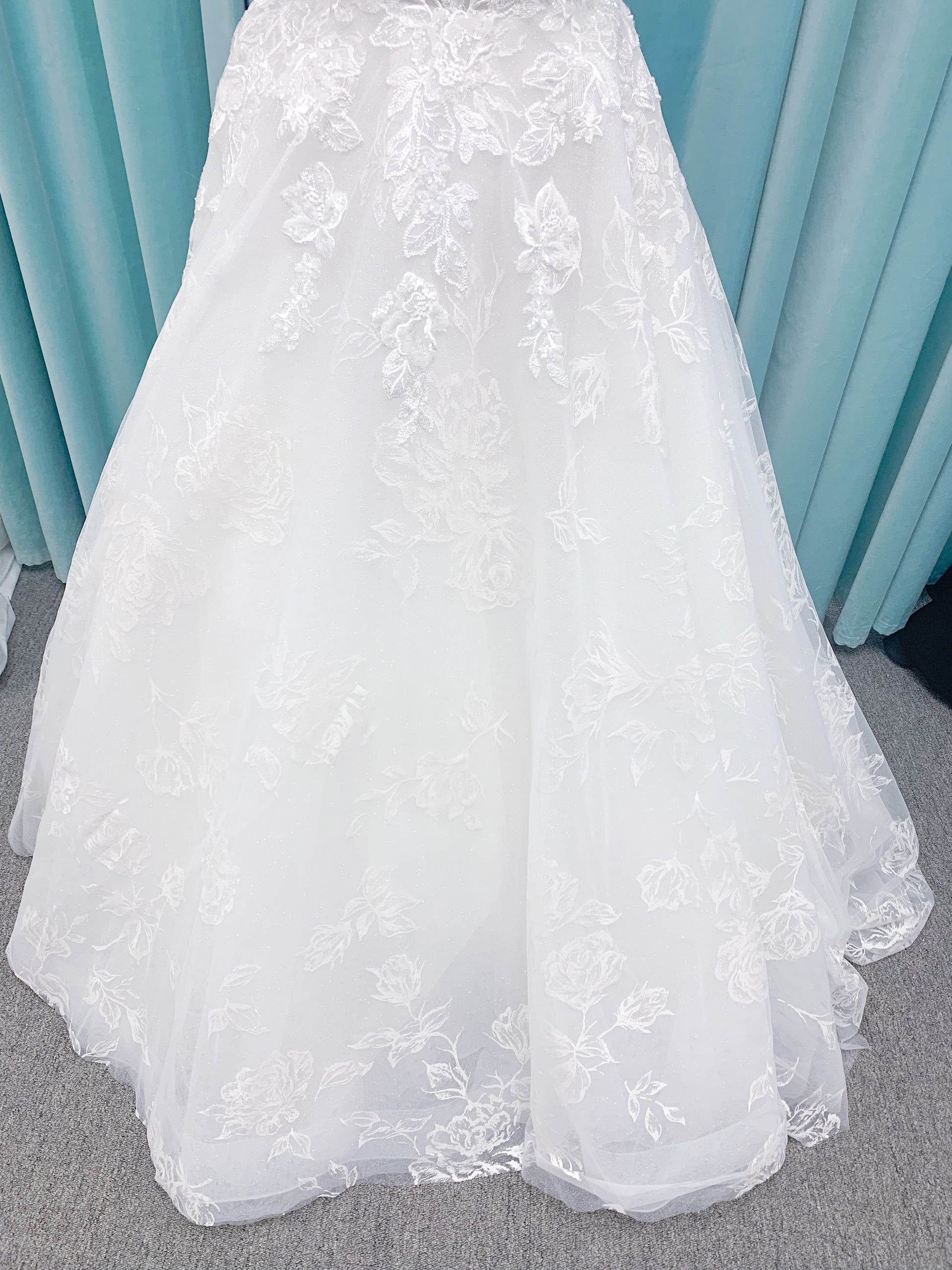 Morilee 2988 Rosie ball gown wedding dress in rose-printed organza over glitter tulle with V-neck, thin straps, structured boning, and voluminous sweeping train.