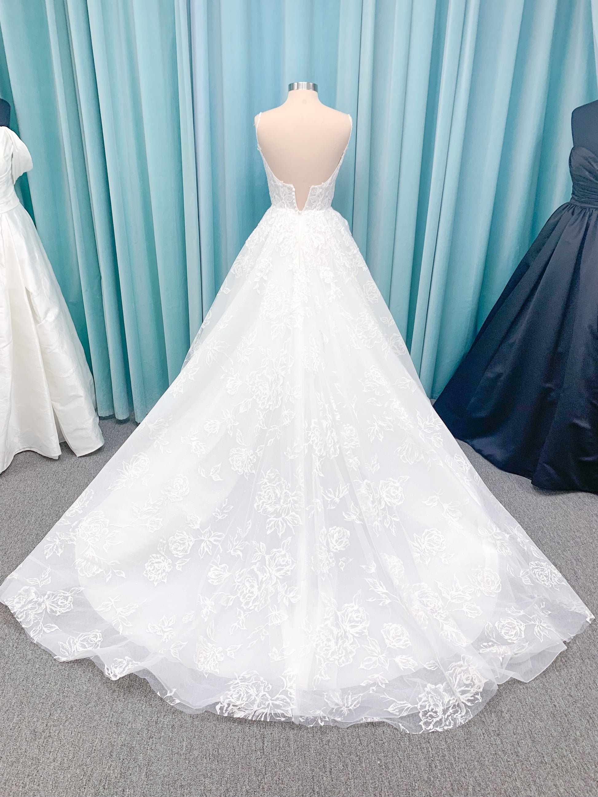 Morilee 2988 Rosie ball gown wedding dress in rose-printed organza over glitter tulle with V-neck, thin straps, structured boning, and voluminous sweeping train.