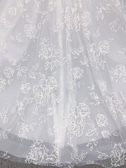 Morilee 2988 Rosie ball gown wedding dress in rose-printed organza over glitter tulle with V-neck, thin straps, structured boning, and voluminous sweeping train.