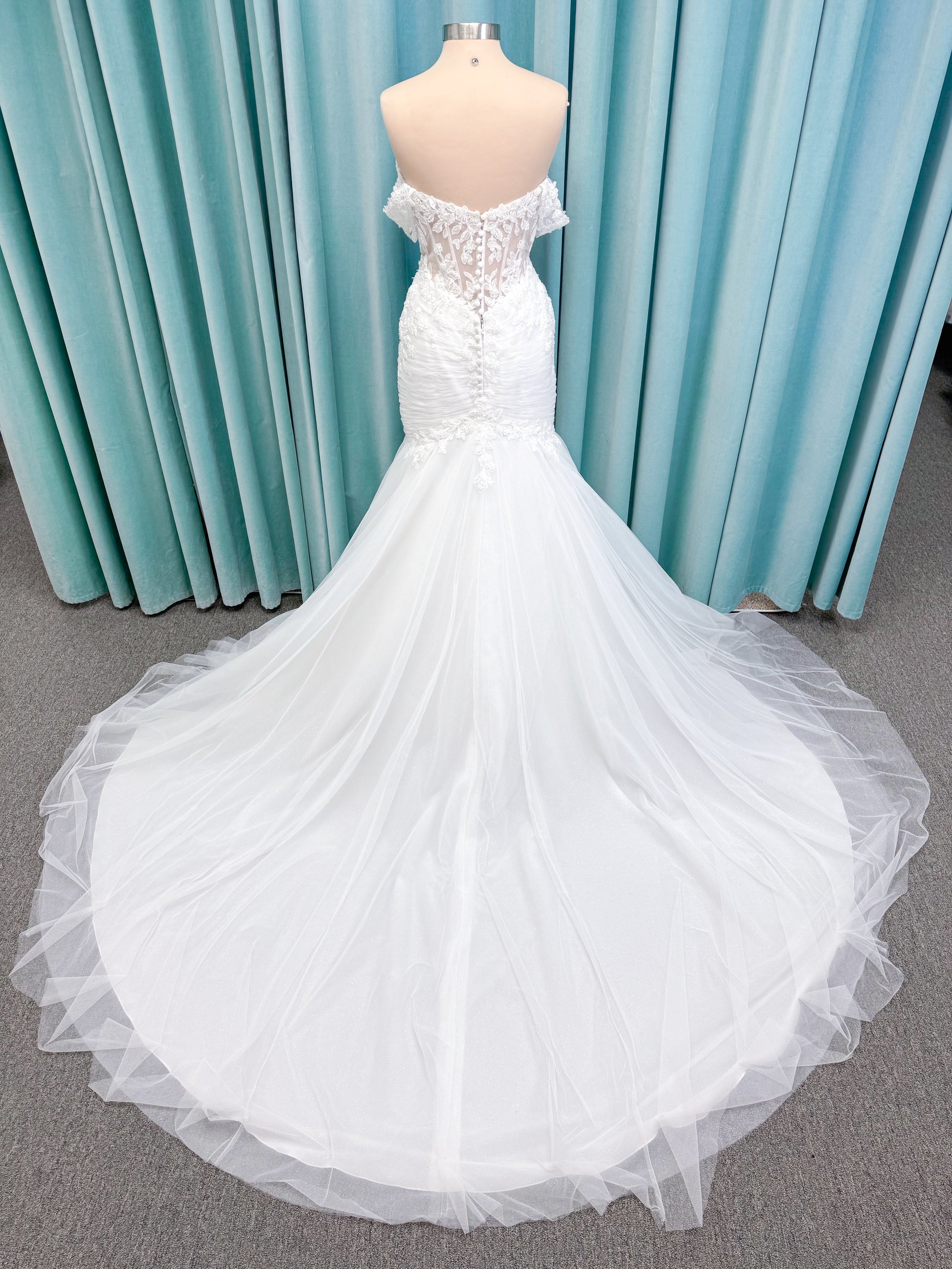 Morilee 4467 Rowena fit and flare wedding dress on mannequin with sheer corset bodice, frosted lace appliques, sweetheart neckline, and detachable off-the-shoulder sleeves
