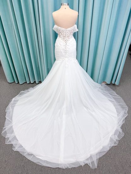 Morilee 4467 Rowena fit and flare wedding dress on mannequin with sheer corset bodice, frosted lace appliques, sweetheart neckline, and detachable off-the-shoulder sleeves