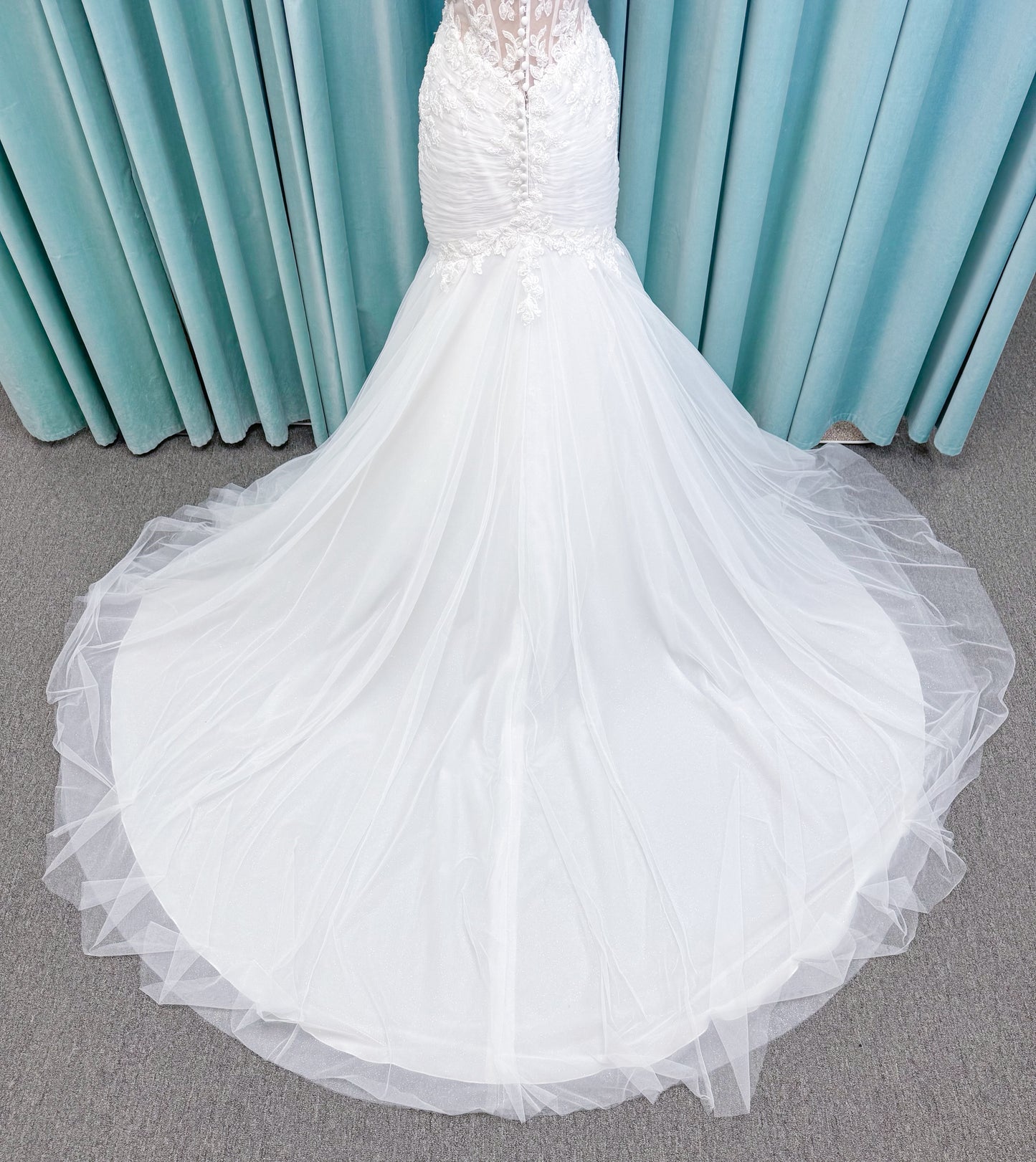 Morilee 4467 Rowena fit and flare wedding dress on mannequin with sheer corset bodice, frosted lace appliques, sweetheart neckline, and detachable off-the-shoulder sleeves