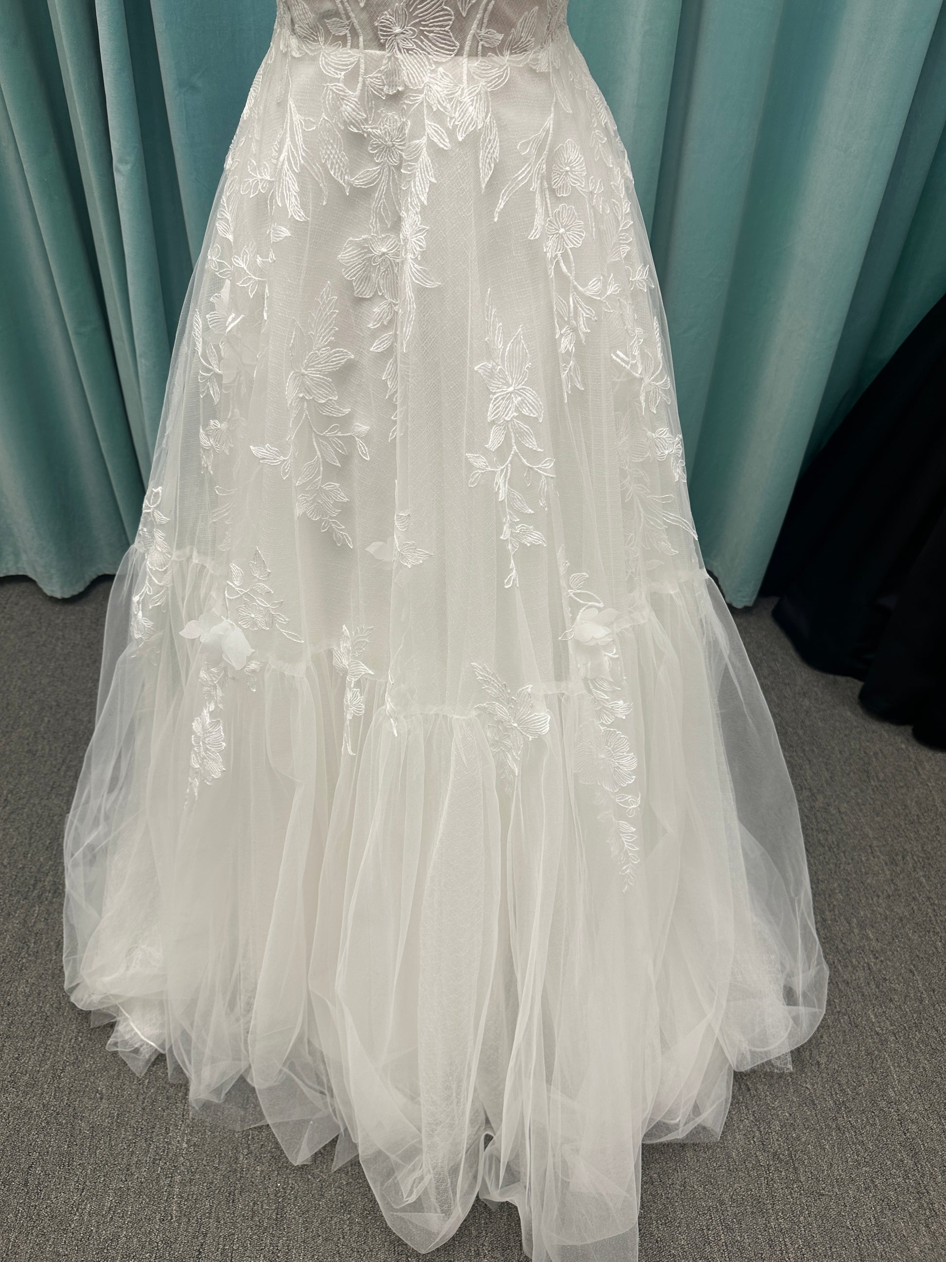 Stella York SY8153 ballgown featuring 3D lace spaghetti strap bodice with sheer V-neckline and layered tulle skirt with floral appliqués