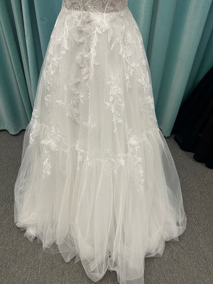 Stella York SY8153 ballgown featuring 3D lace spaghetti strap bodice with sheer V-neckline and layered tulle skirt with floral appliqués