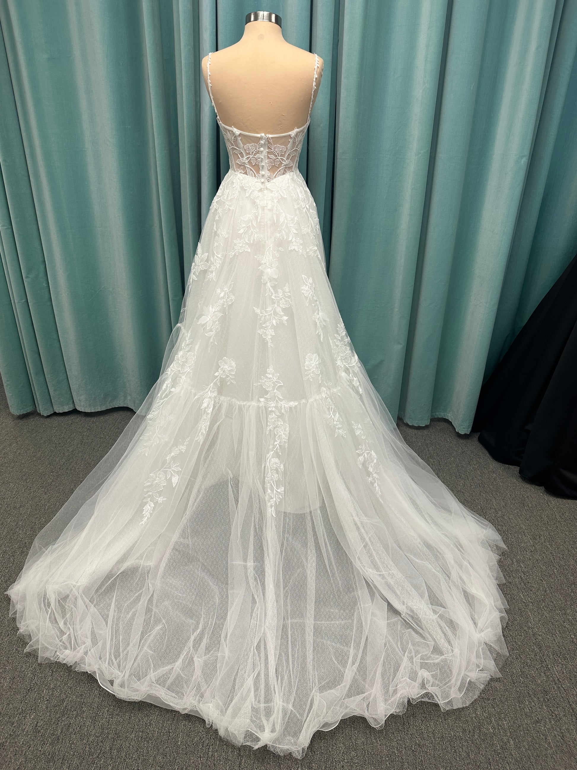 Stella York SY8153 ballgown featuring 3D lace spaghetti strap bodice with sheer V-neckline and layered tulle skirt with floral appliqués