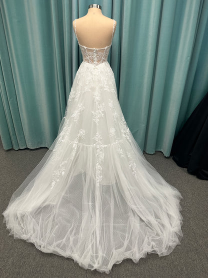 Stella York SY8153 ballgown featuring 3D lace spaghetti strap bodice with sheer V-neckline and layered tulle skirt with floral appliqués