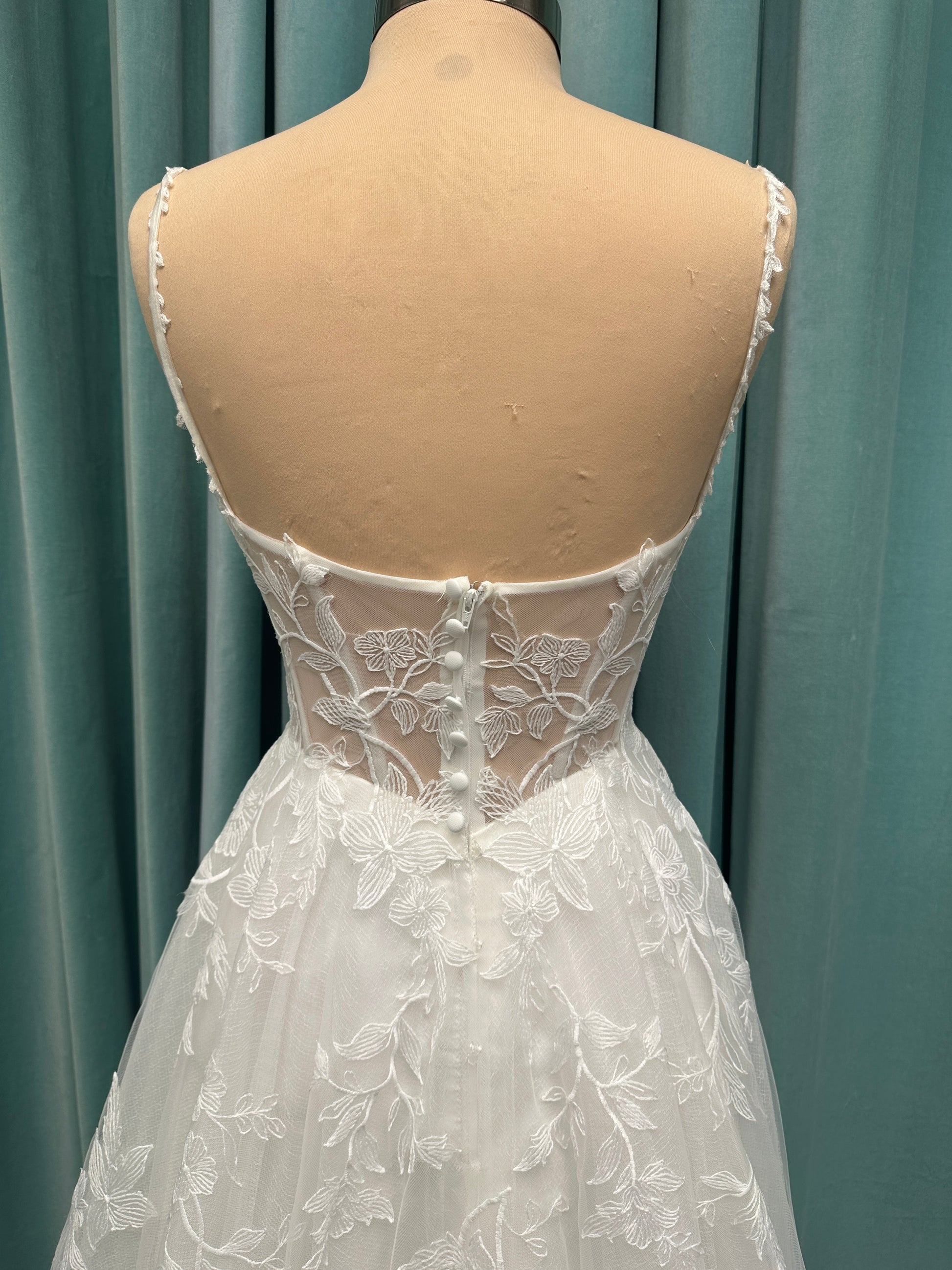 Stella York SY8153 ballgown featuring 3D lace spaghetti strap bodice with sheer V-neckline and layered tulle skirt with floral appliqués