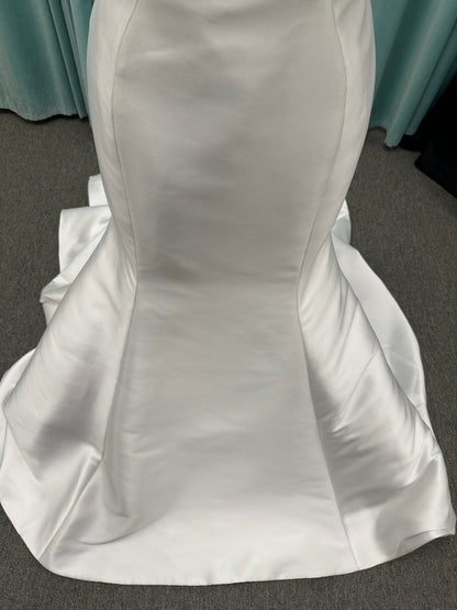 Strapless Mikado fit-and-flare wedding dress with sweetheart neckline, bow waist detail, and dramatic flared train by Stella York