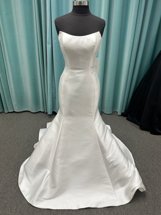 Strapless Mikado fit-and-flare wedding dress with sweetheart neckline, bow waist detail, and dramatic flared train by Stella York