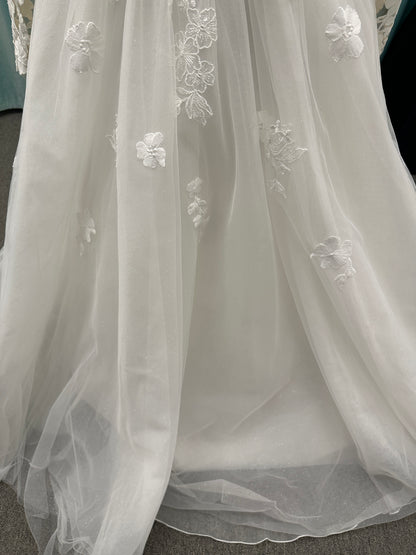 Stella York Style 8012 lace and tulle ballgown wedding dress with sheer sweetheart bodice, off-the-shoulder long lace sleeves, and full princess skirt