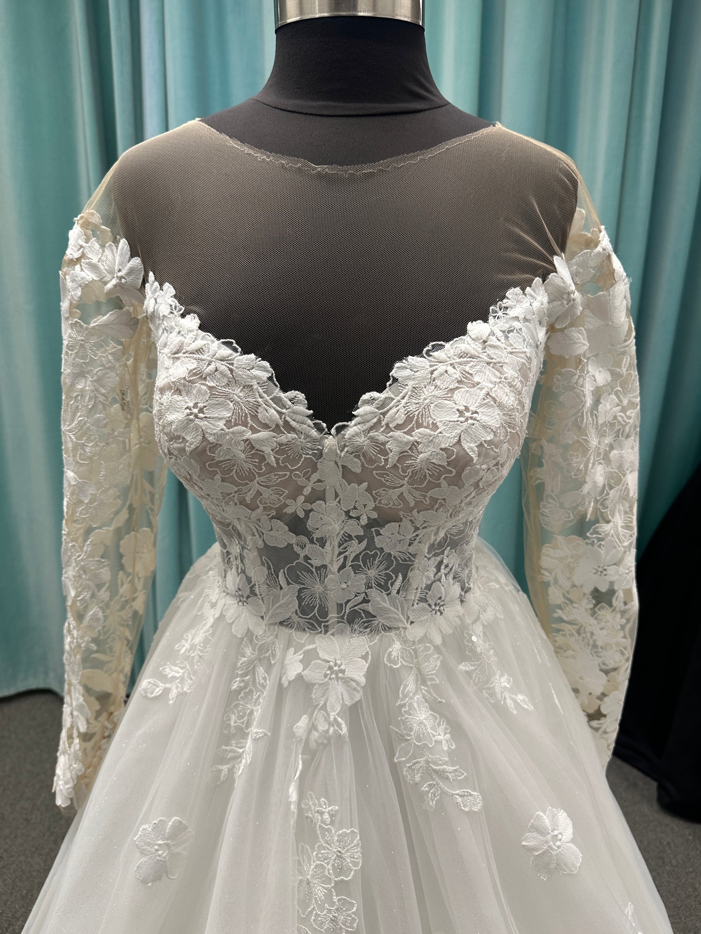 Stella York Style 8012 lace and tulle ballgown wedding dress with sheer sweetheart bodice, off-the-shoulder long lace sleeves, and full princess skirt