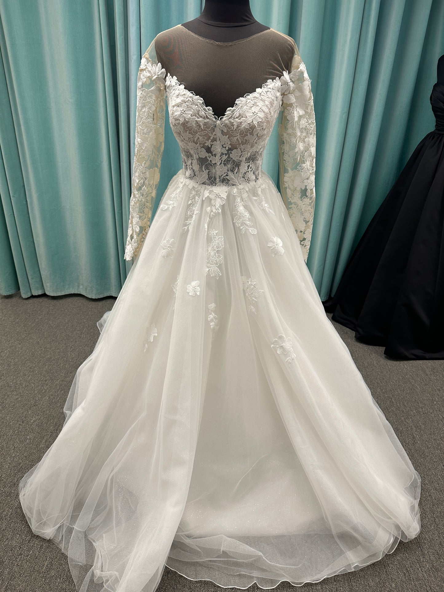 Stella York Style 8012 lace and tulle ballgown wedding dress with sheer sweetheart bodice, off-the-shoulder long lace sleeves, and full princess skirt