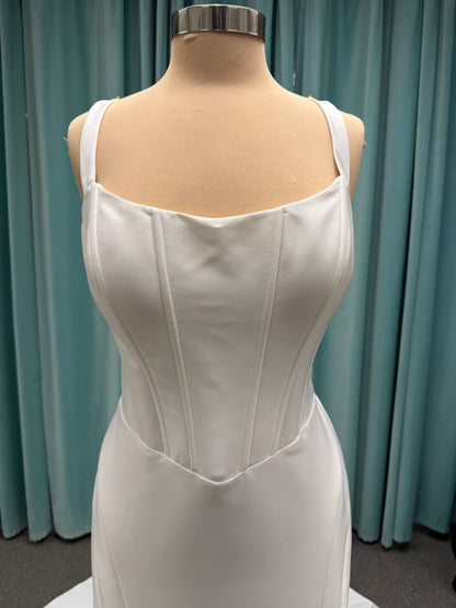 Stella York SY8148 ivory fit-and-flare wedding dress on mannequin featuring a modest scoop neckline, wide straps, and structured corset bodice.
