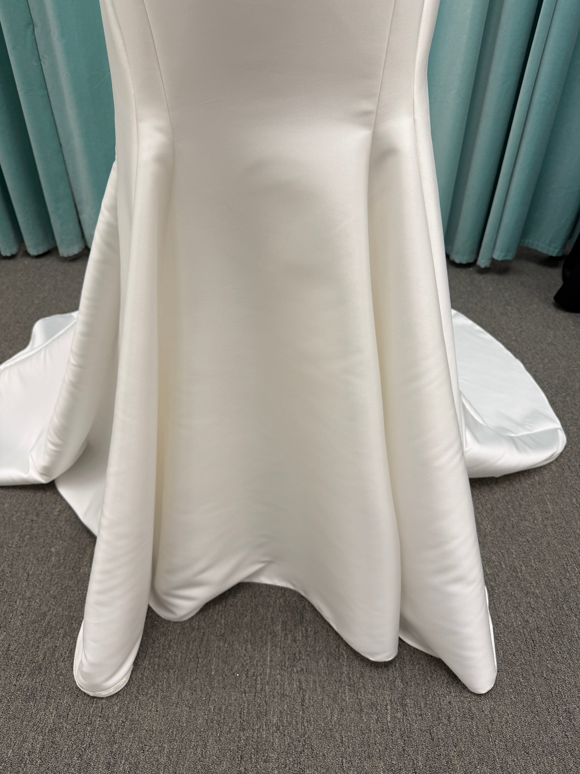 Stella York SY8148 ivory fit-and-flare wedding dress on mannequin featuring a modest scoop neckline, wide straps, and structured corset bodice.
