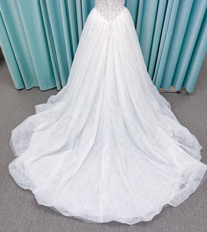 Morilee 2714 Seattle ballgown wedding dress on mannequin with crescent neckline, beaded embroidered lace, basque waist, and detachable illusion sleeves