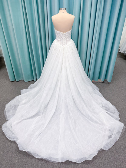 Morilee 2714 Seattle ballgown wedding dress on mannequin with crescent neckline, beaded embroidered lace, basque waist, and detachable illusion sleeves