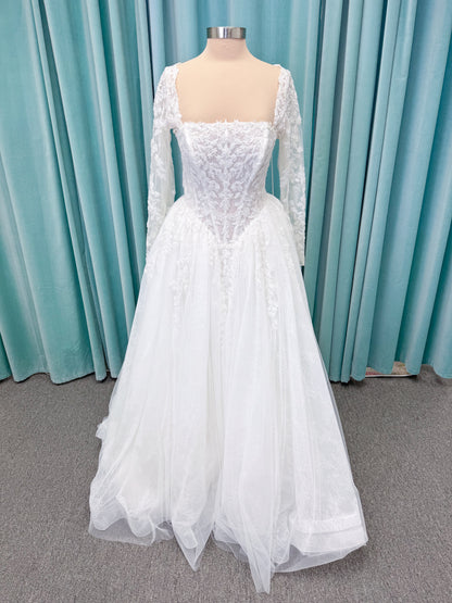 Morilee 2714 Seattle ballgown wedding dress on mannequin with crescent neckline, beaded embroidered lace, basque waist, and detachable illusion sleeves