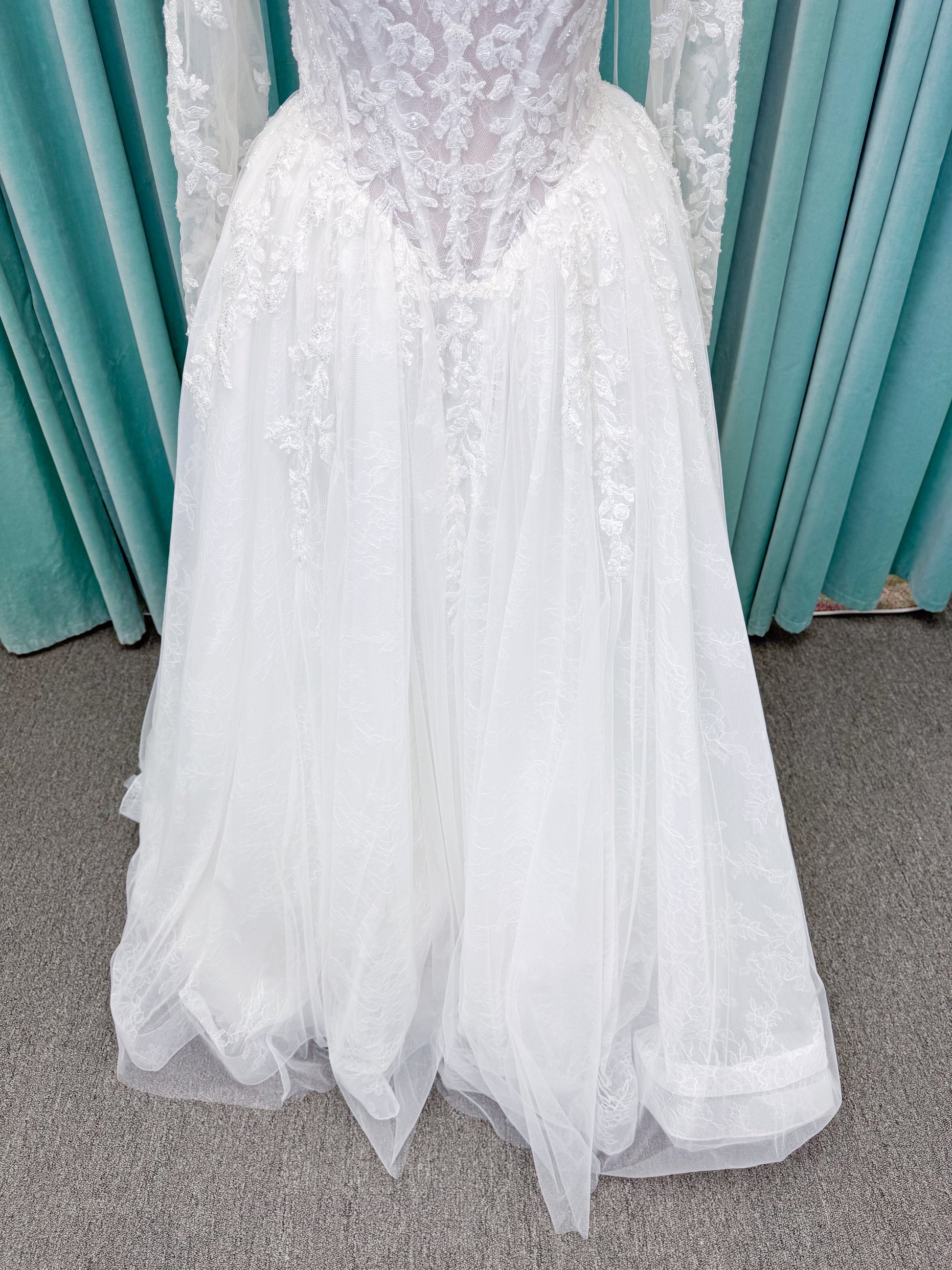 Morilee 2714 Seattle ballgown wedding dress on mannequin with crescent neckline, beaded embroidered lace, basque waist, and detachable illusion sleeves