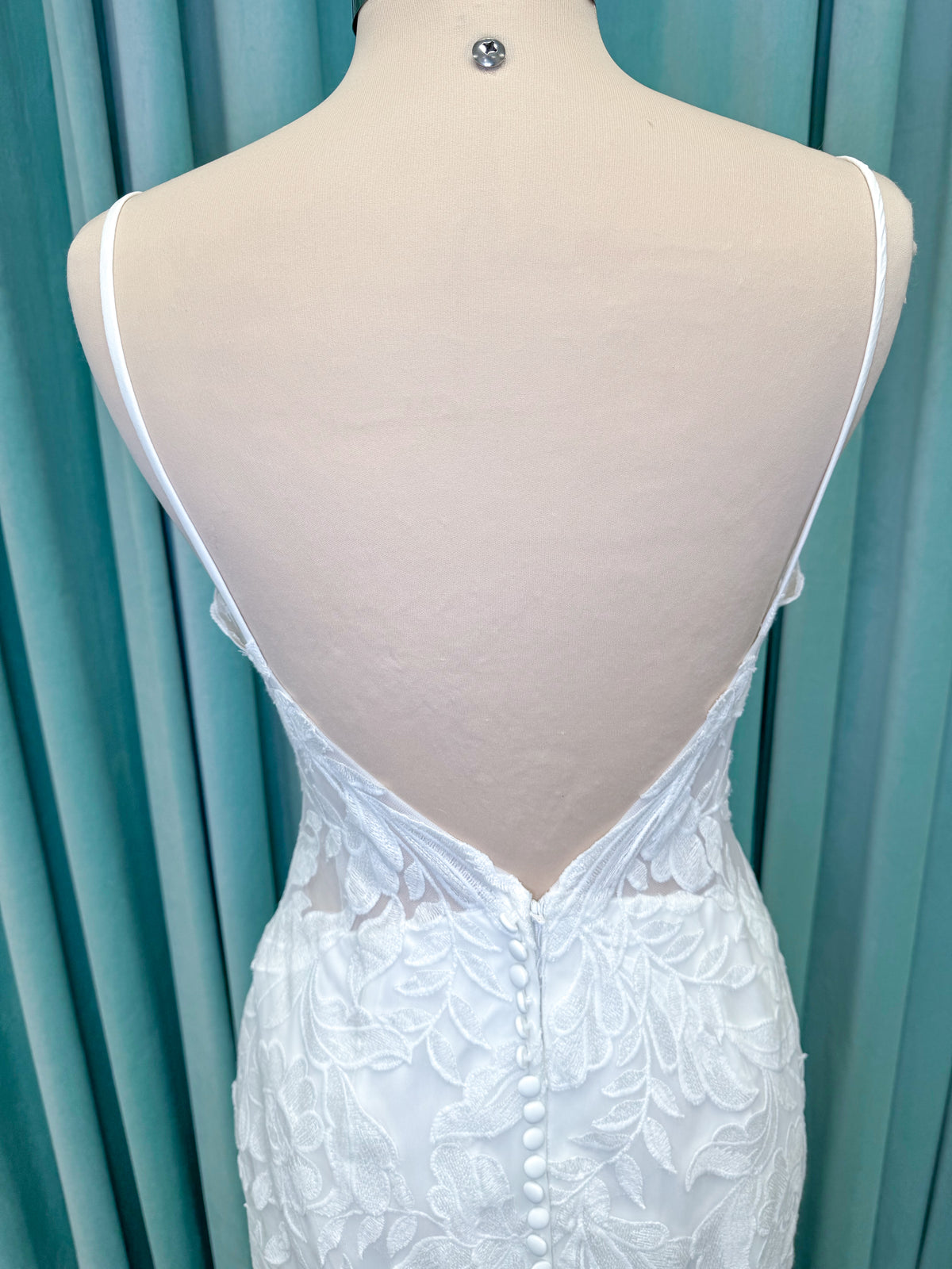 Morilee 2904 Selene fit and flare wedding dress on mannequin with spaghetti straps, plunge neckline, illusion side cutouts, and open back