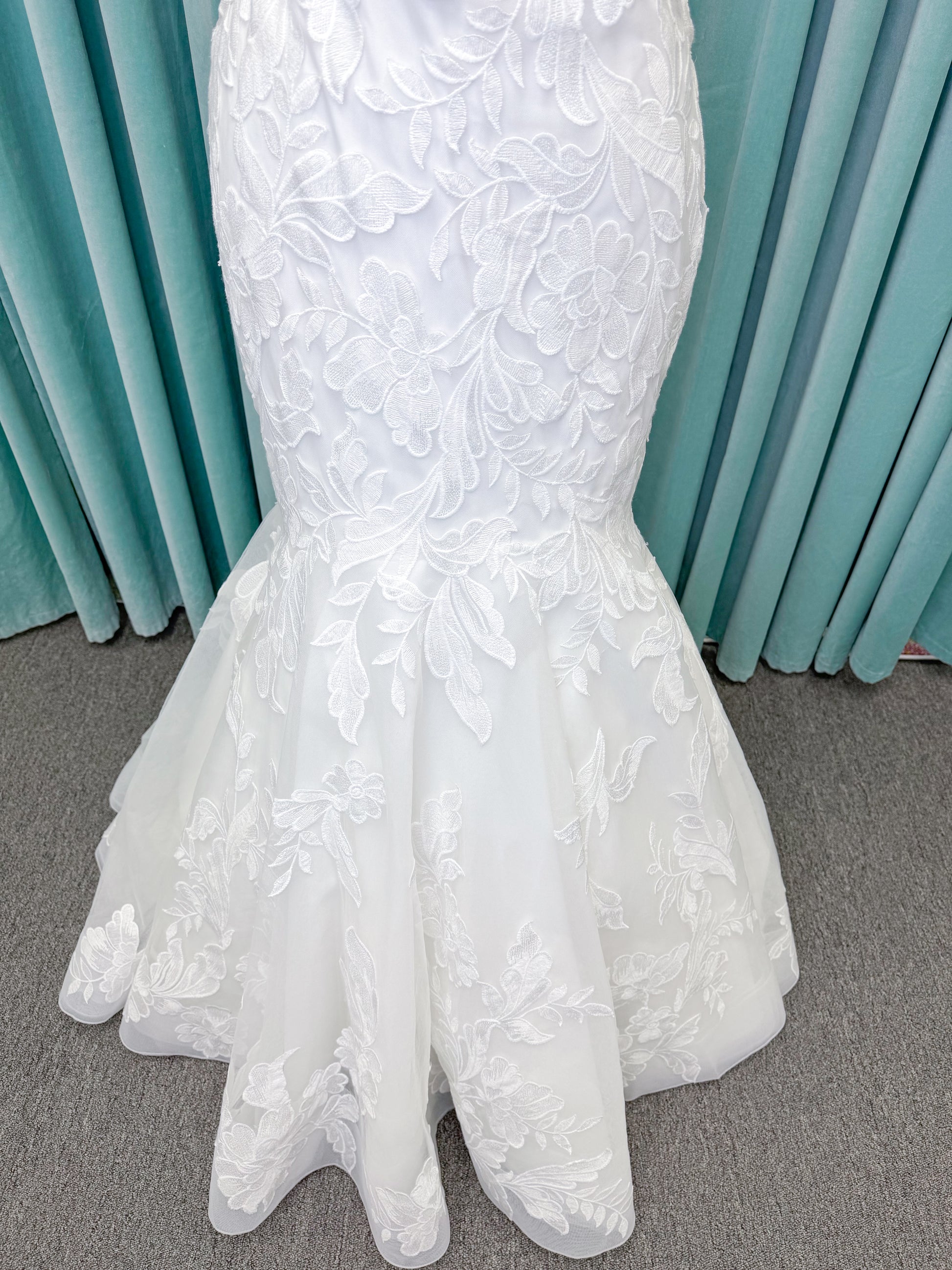 Morilee 2904 Selene fit and flare wedding dress on mannequin with spaghetti straps, plunge neckline, illusion side cutouts, and open back