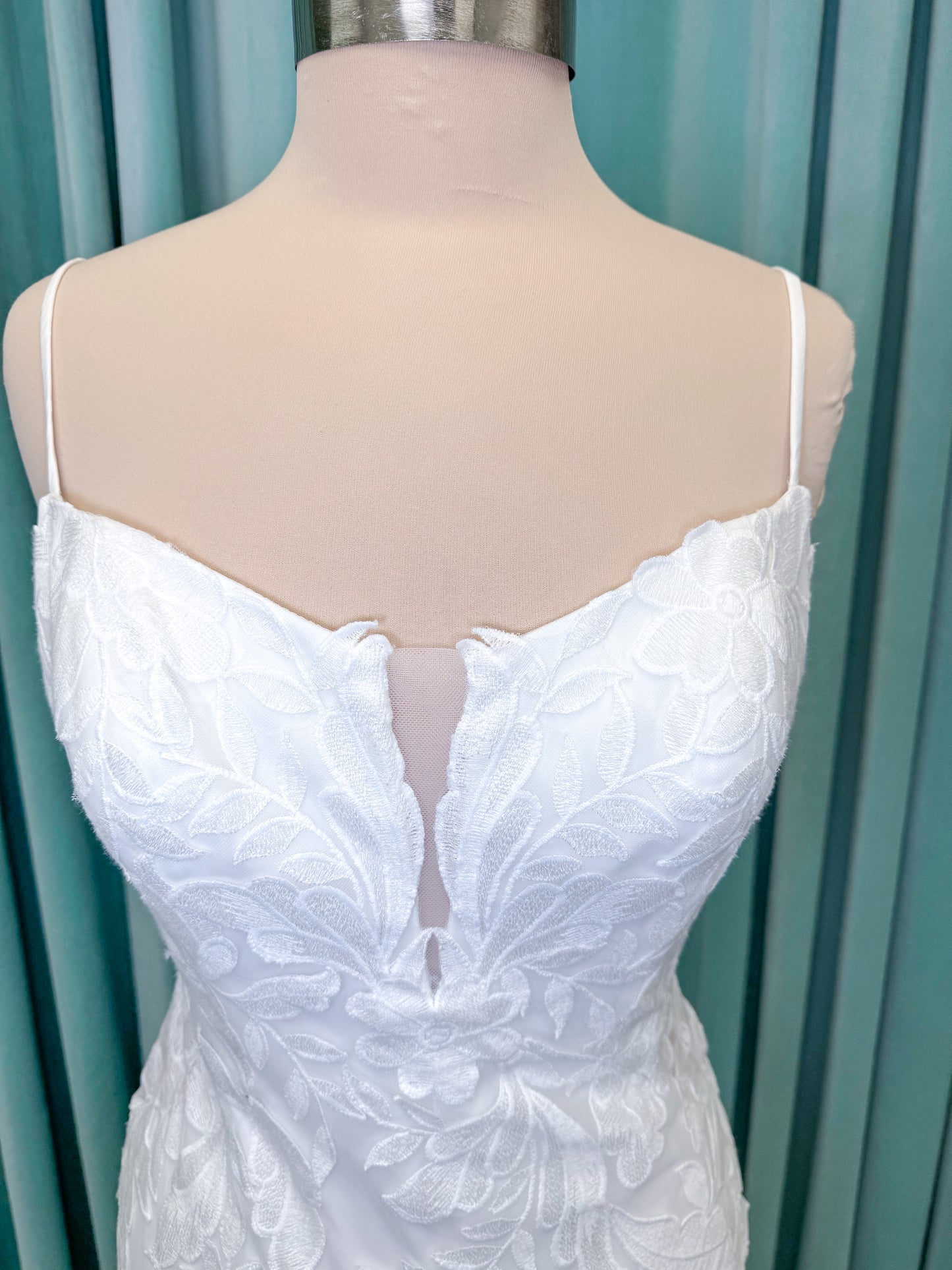 Morilee 2904 Selene fit and flare wedding dress on mannequin with spaghetti straps, plunge neckline, illusion side cutouts, and open back