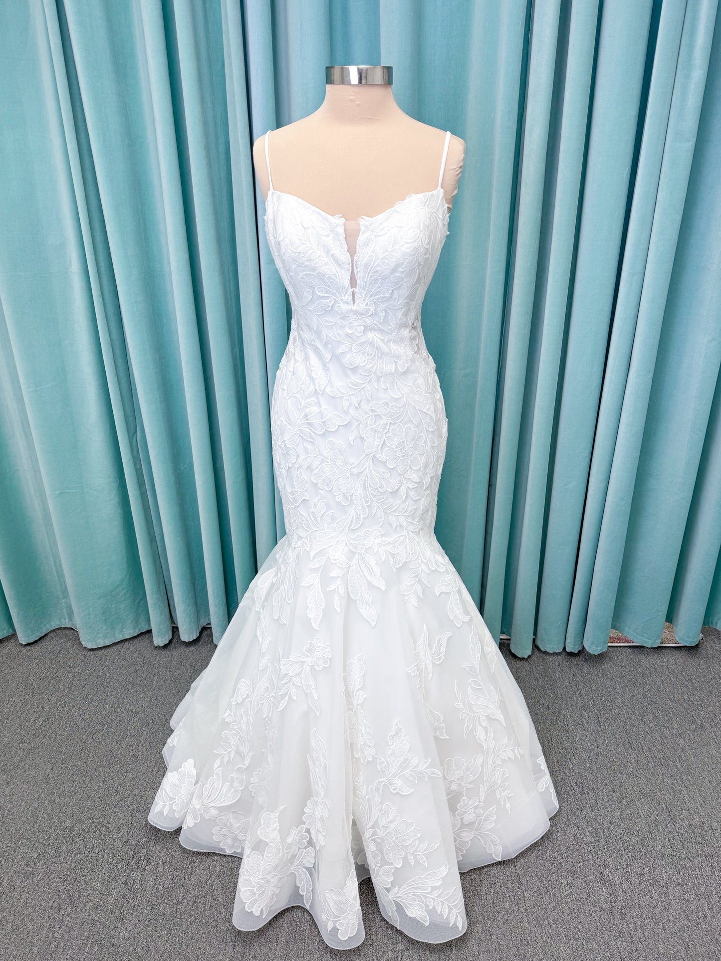 Morilee 2904 Selene fit and flare wedding dress on mannequin with spaghetti straps, plunge neckline, illusion side cutouts, and open back