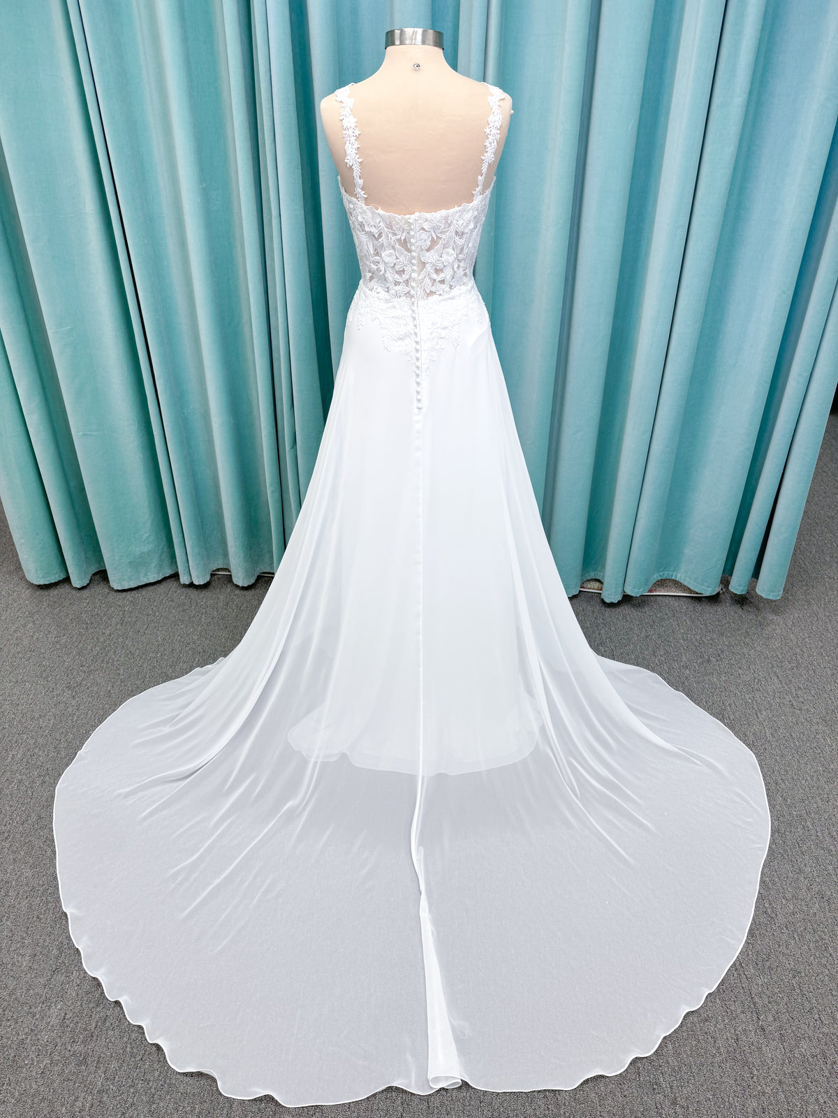 Morilee 15108 Senna boho A-line wedding dress on mannequin with square neckline, 3D floral lace bodice, and flowing chiffon skirt
