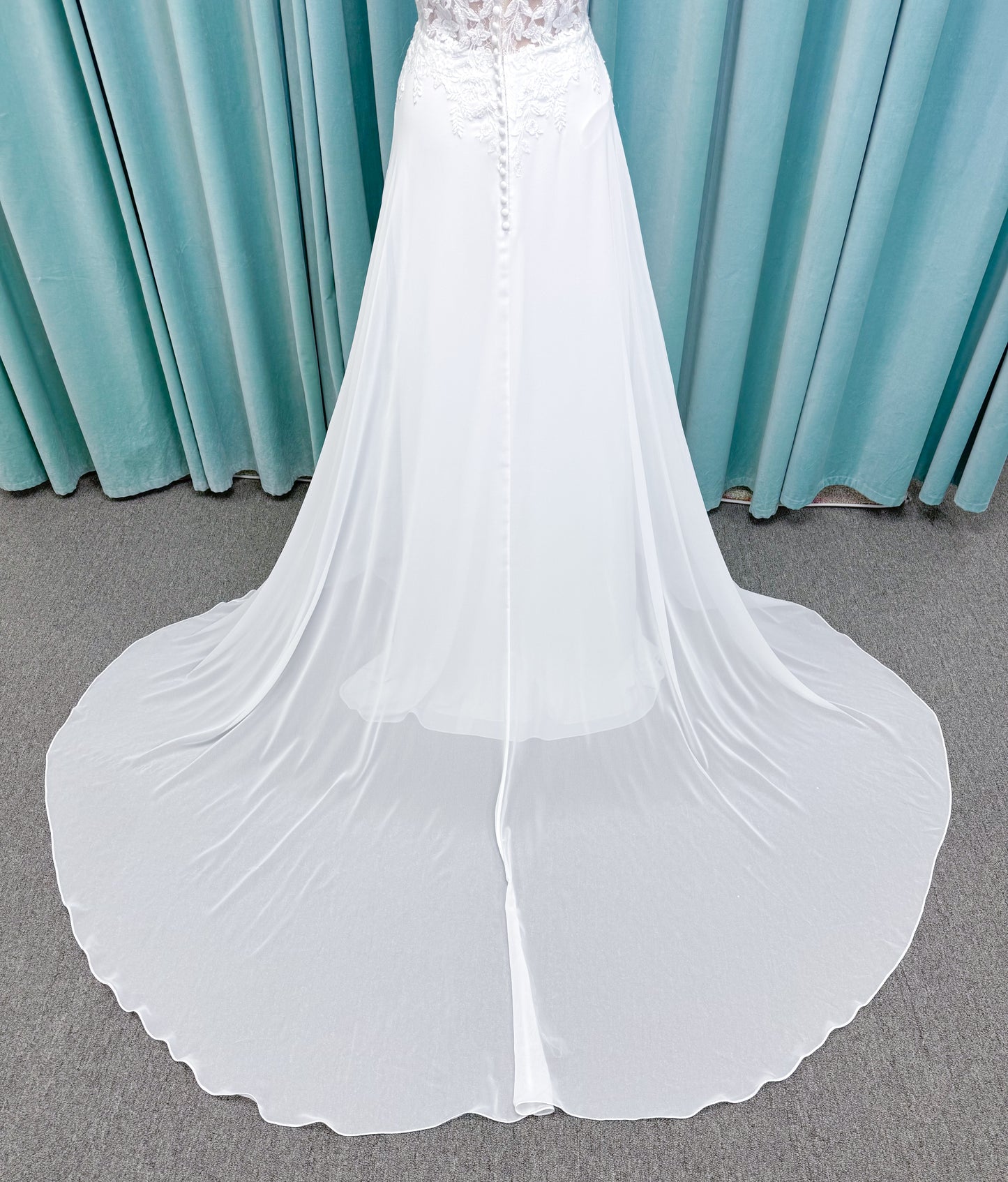 Morilee 15108 Senna boho A-line wedding dress on mannequin with square neckline, 3D floral lace bodice, and flowing chiffon skirt