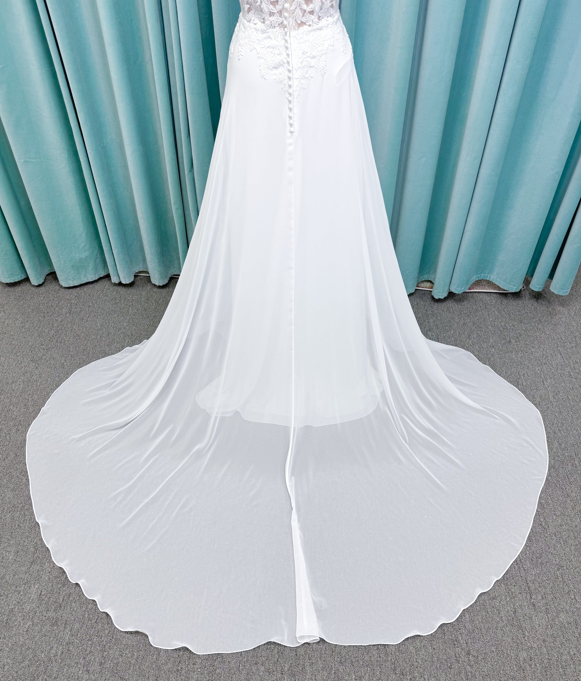 Morilee 15108 Senna boho A-line wedding dress on mannequin with square neckline, 3D floral lace bodice, and flowing chiffon skirt