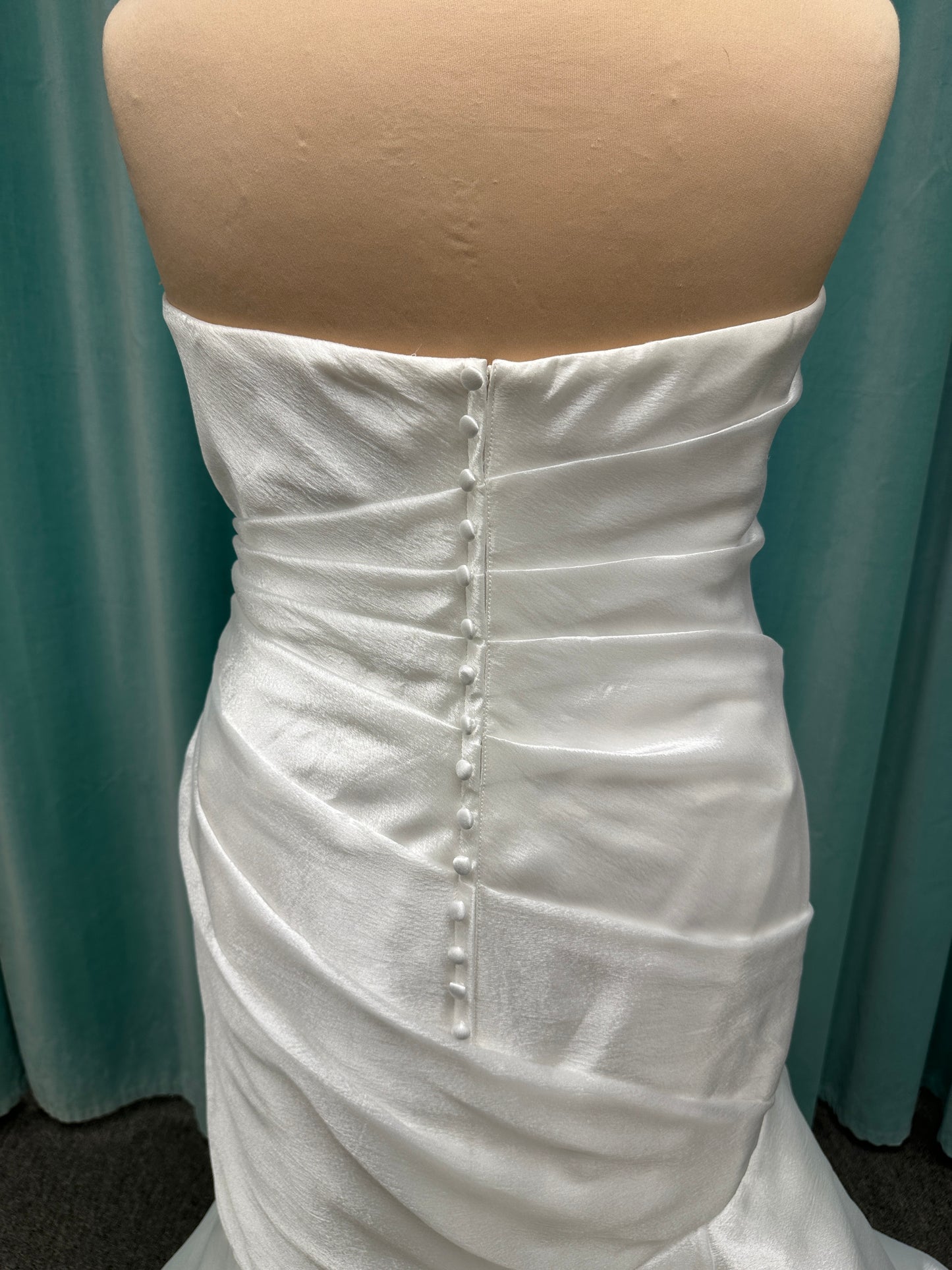 Ruched strapless fit-and-flare wedding dress with cat-eye neckline, asymmetrical skirt, and dramatic pickups by Stella York Style SY8123