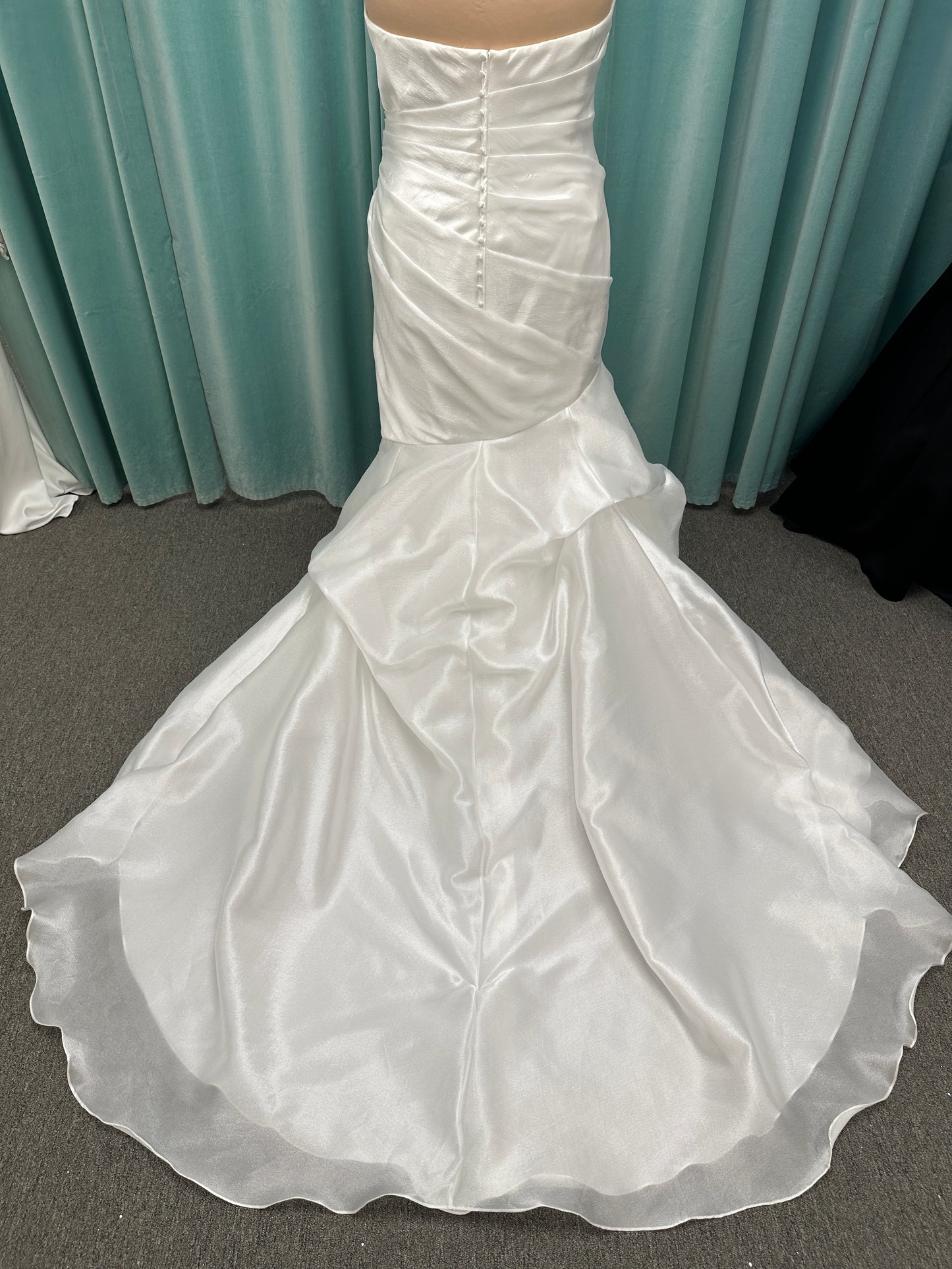 Ruched strapless fit-and-flare wedding dress with cat-eye neckline, asymmetrical skirt, and dramatic pickups by Stella York Style SY8123