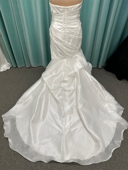 Ruched strapless fit-and-flare wedding dress with cat-eye neckline, asymmetrical skirt, and dramatic pickups by Stella York Style SY8123