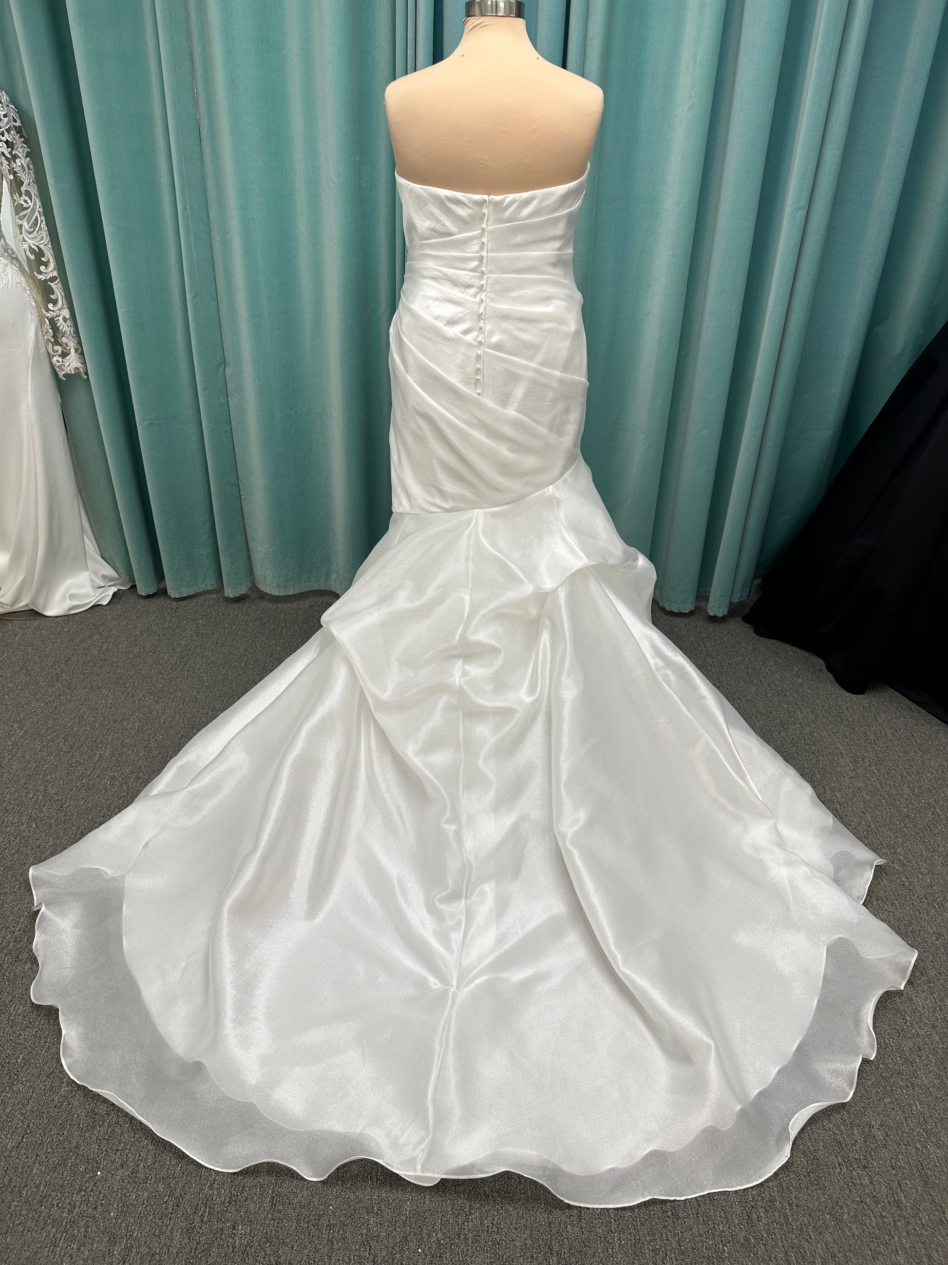 Ruched strapless fit-and-flare wedding dress with cat-eye neckline, asymmetrical skirt, and dramatic pickups by Stella York Style SY8123