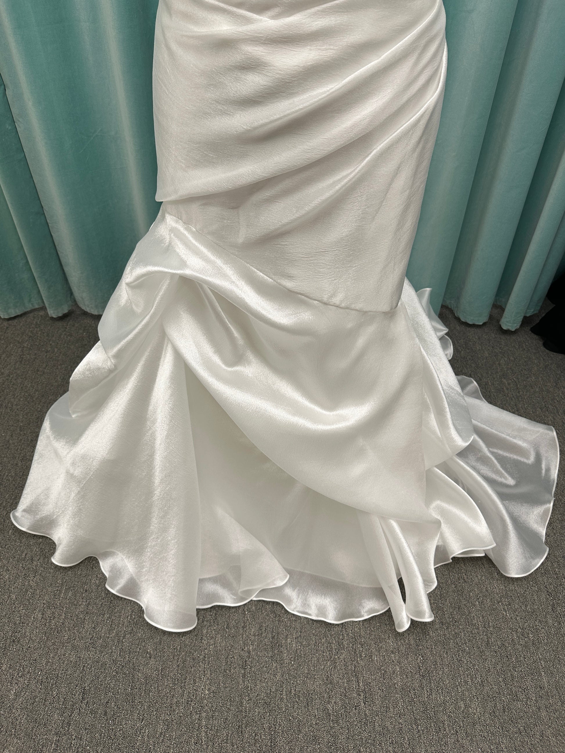 Ruched strapless fit-and-flare wedding dress with cat-eye neckline, asymmetrical skirt, and dramatic pickups by Stella York Style SY8123