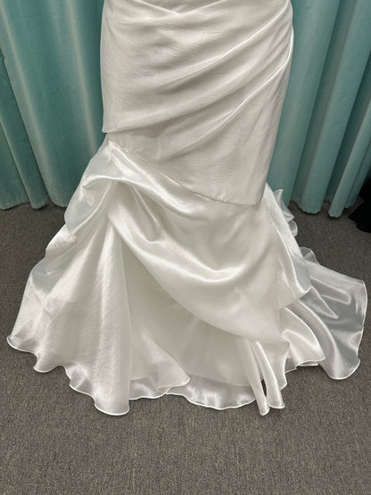 Ruched strapless fit-and-flare wedding dress with cat-eye neckline, asymmetrical skirt, and dramatic pickups by Stella York Style SY8123
