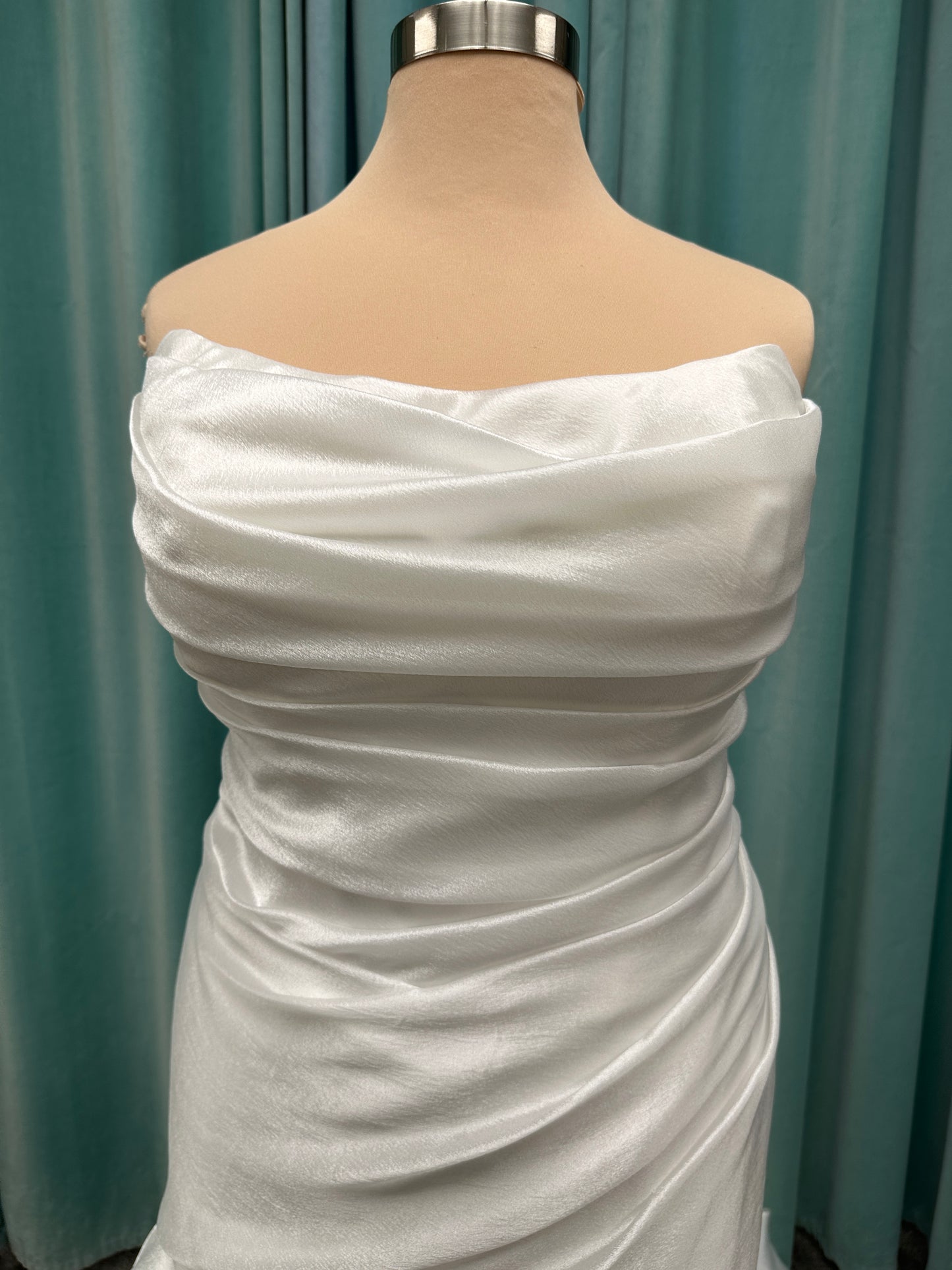 Ruched strapless fit-and-flare wedding dress with cat-eye neckline, asymmetrical skirt, and dramatic pickups by Stella York Style SY8123