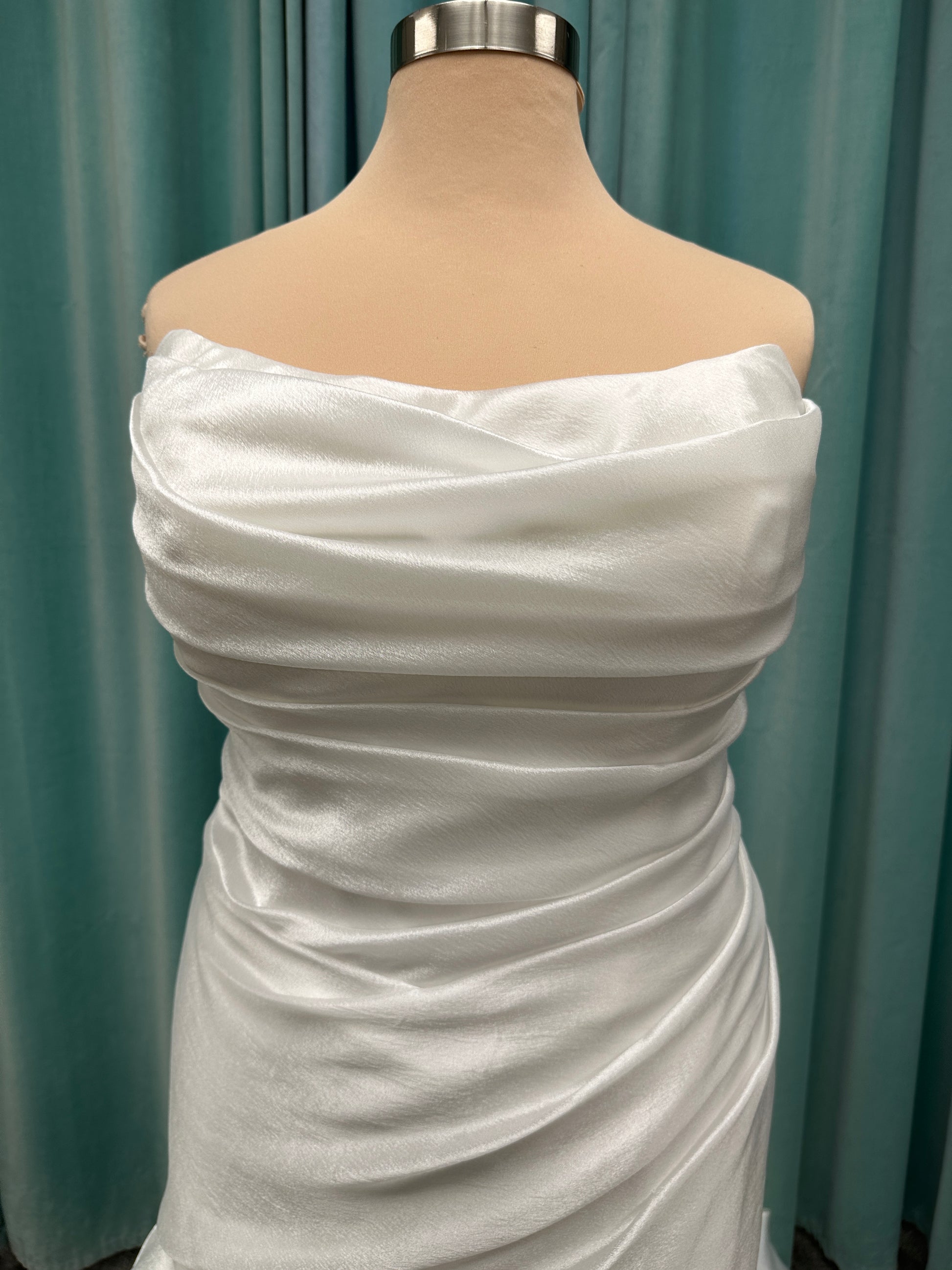 Ruched strapless fit-and-flare wedding dress with cat-eye neckline, asymmetrical skirt, and dramatic pickups by Stella York Style SY8123
