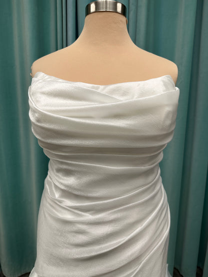 Ruched strapless fit-and-flare wedding dress with cat-eye neckline, asymmetrical skirt, and dramatic pickups by Stella York Style SY8123