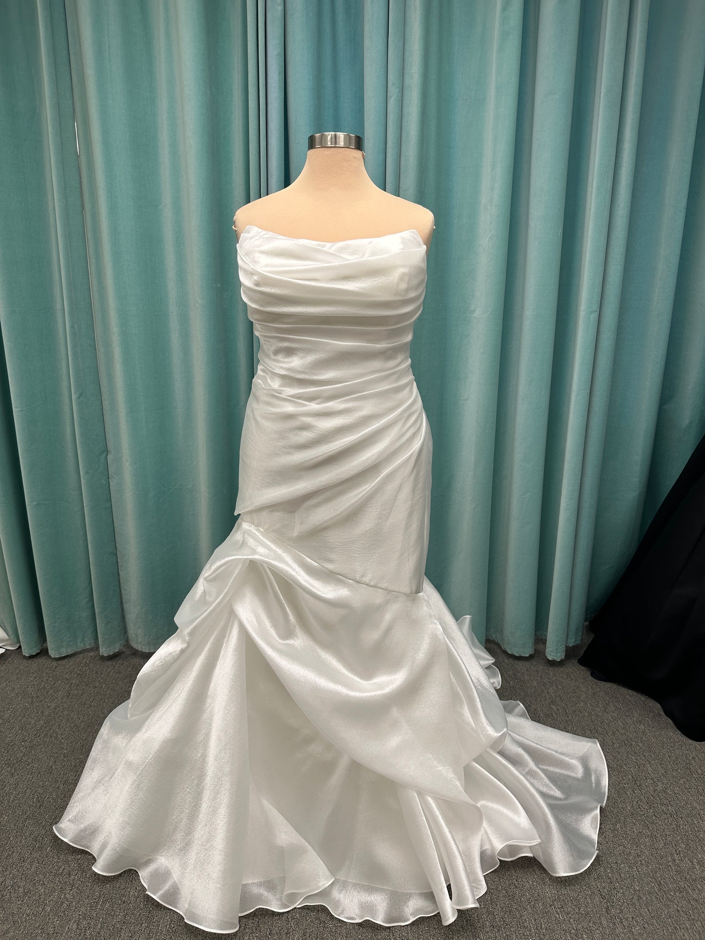 Ruched strapless fit-and-flare wedding dress with cat-eye neckline, asymmetrical skirt, and dramatic pickups by Stella York Style SY8123