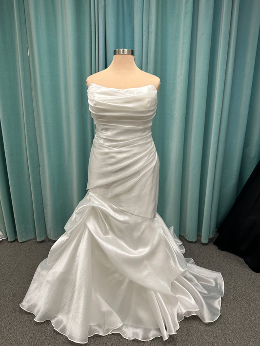 Ruched strapless fit-and-flare wedding dress with cat-eye neckline, asymmetrical skirt, and dramatic pickups by Stella York Style SY8123