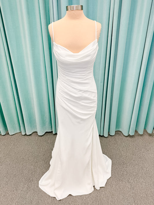 Stella York SY8224 sheath wedding dress on mannequin with spaghetti straps, draped scoop neckline, ruched crepe bodice, front slit, and detachable back cowl