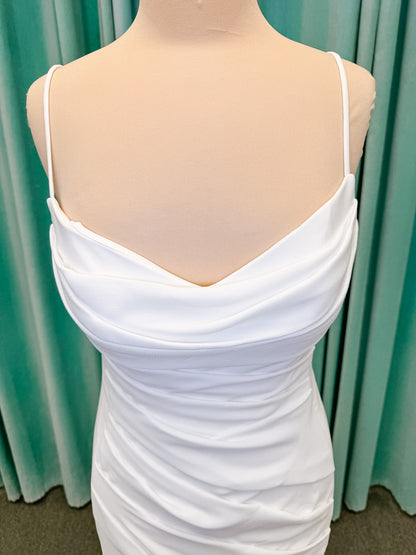 Stella York SY8224 sheath wedding dress on mannequin with spaghetti straps, draped scoop neckline, ruched crepe bodice, front slit, and detachable back cowl