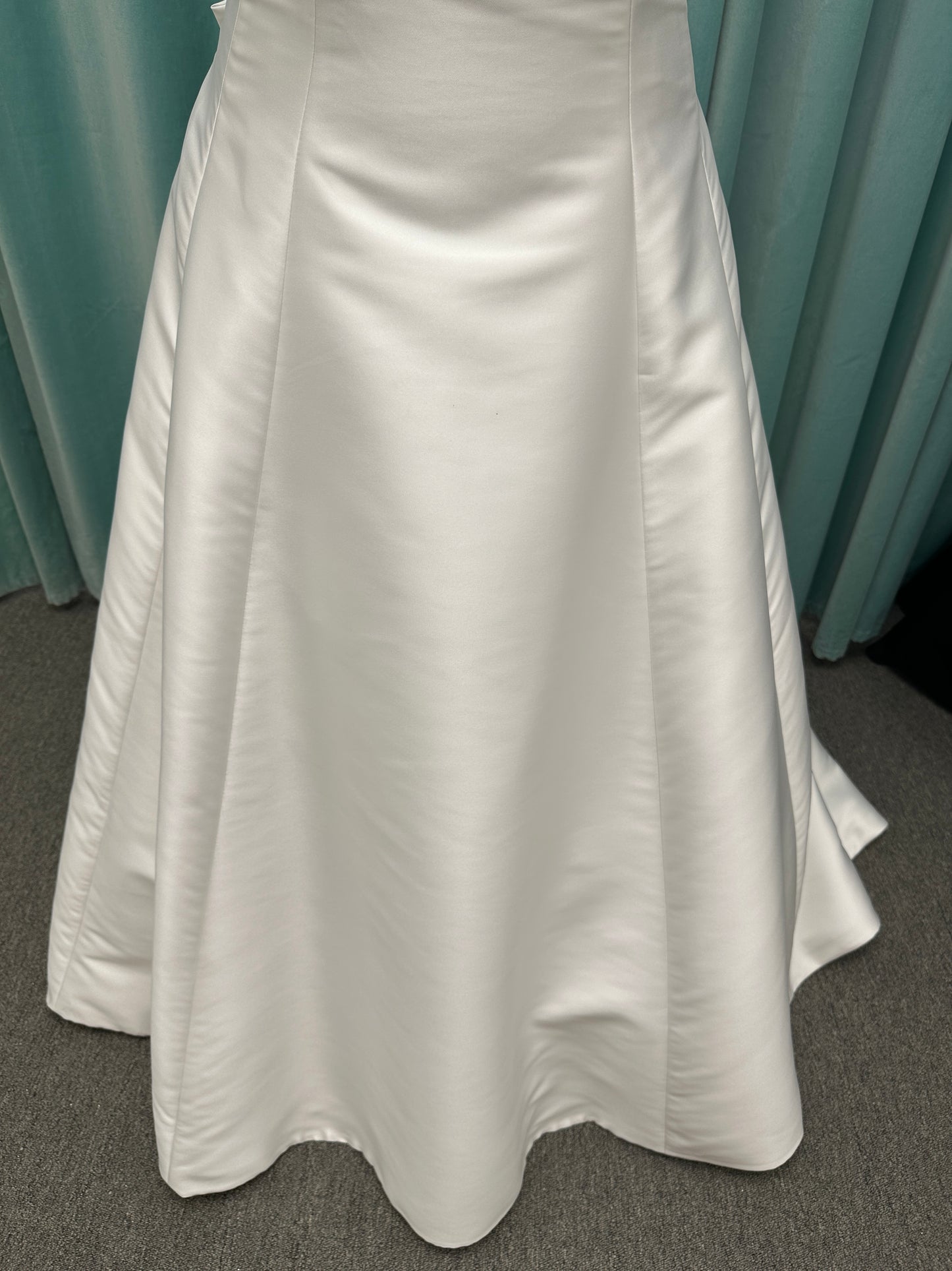 Minimalist Mikado A-line wedding dress with square neckline, clean seams, subtle side cutouts, and detachable oversized bow at the back