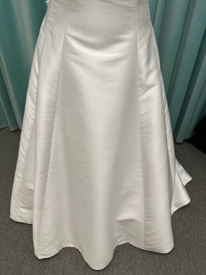 Minimalist Mikado A-line wedding dress with square neckline, clean seams, subtle side cutouts, and detachable oversized bow at the back