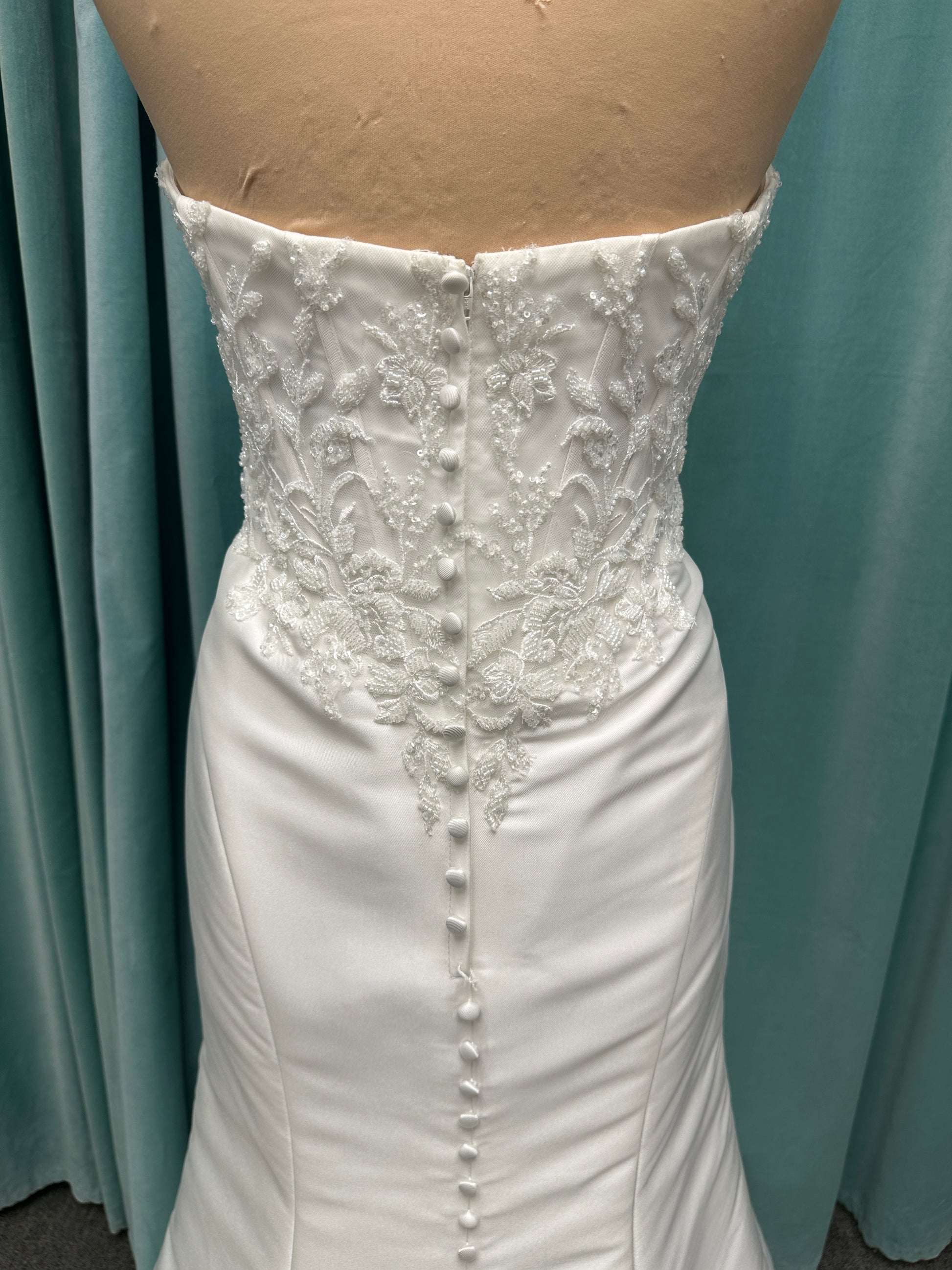 Strapless Mikado fit-and-flare wedding dress with corset bodice, exposed boning, lace detailing, and dramatic lace train by Stella York Style SY8163
